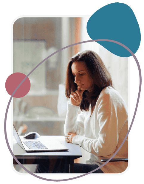A woman sits at a desk, looking thoughtfully at a laptop screen. She rests her chin on her hand. Abstract shapes in blue and red are overlaid on the image.