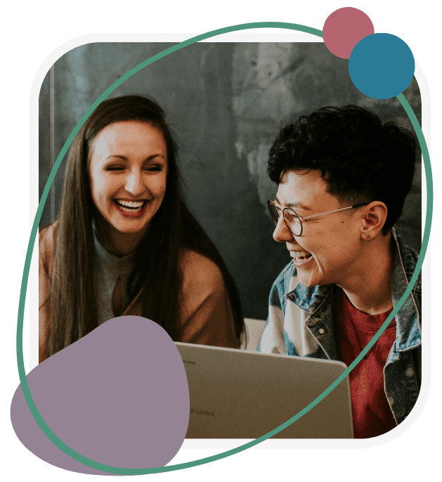 Two people laughing while looking at a laptop, conveying joy and connection. Background has abstract shapes adding a playful touch.