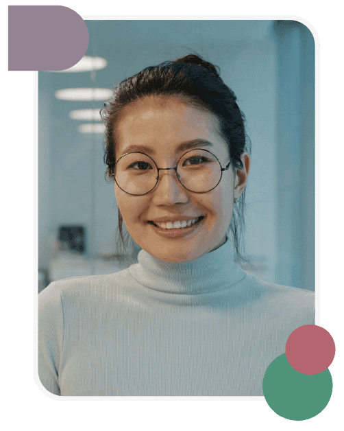A person with glasses and a light turtleneck smiles at the camera in an office setting; geometric shapes decorate the image corners.