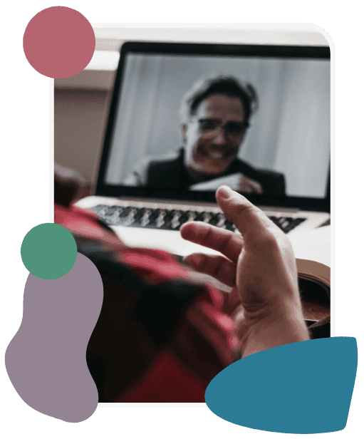 A person in a red shirt participates in a video call on a laptop, with an older man smiling on the screen. The mood is casual and friendly. Colorful abstract shapes decorate the border.